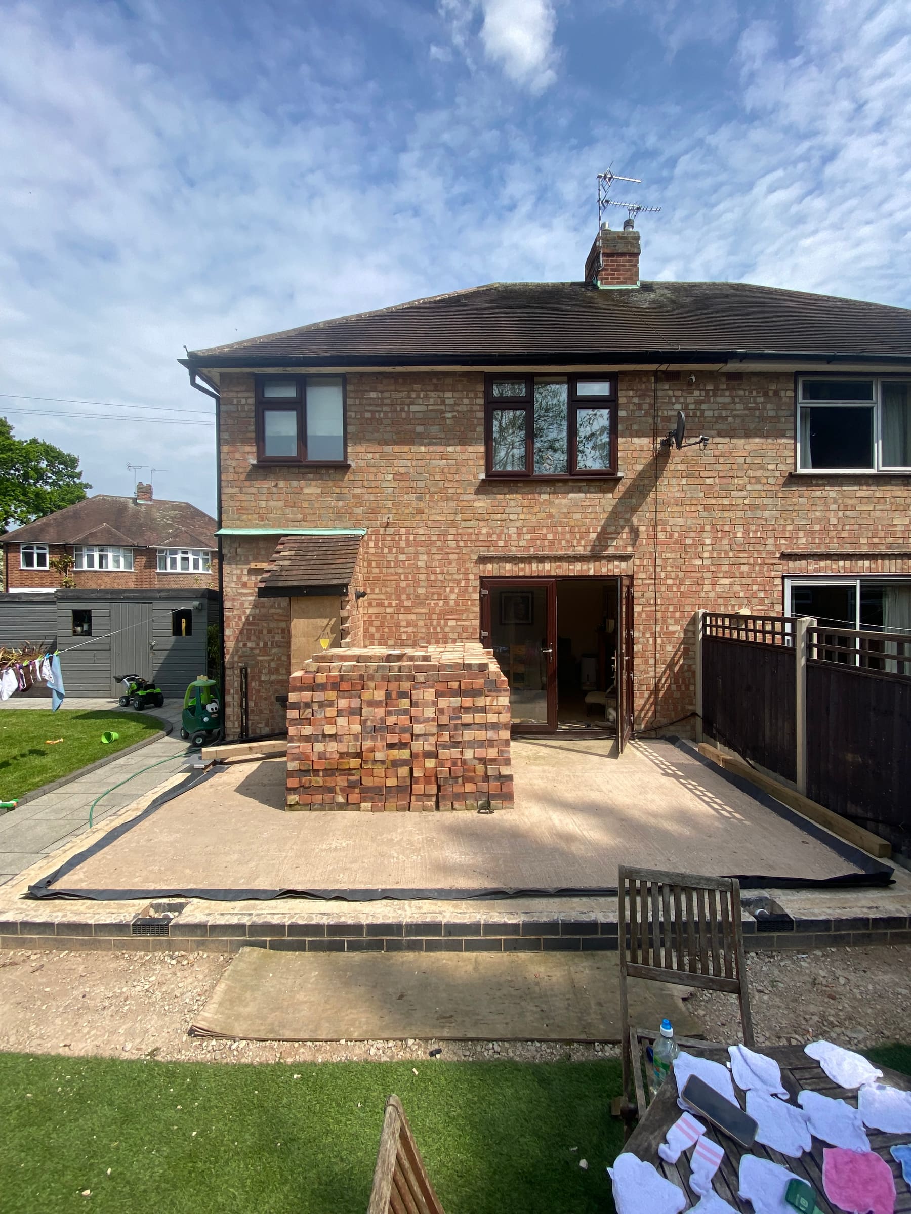 Extension base stage with reclaimed bricks stacked ready