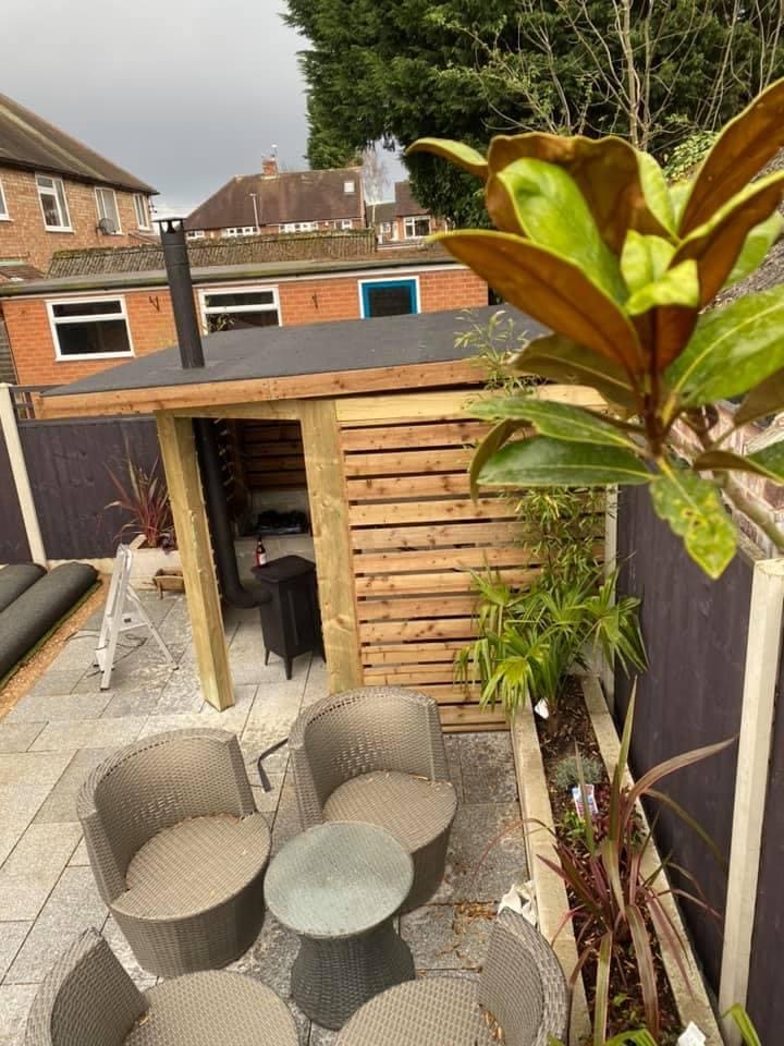 Pergola and log store over the patio
