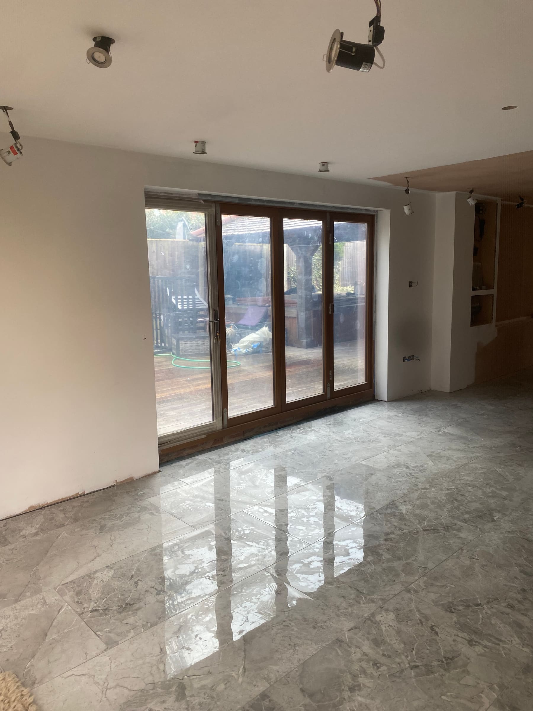 Polished floor and timber bi-fold doors in a finished renovation