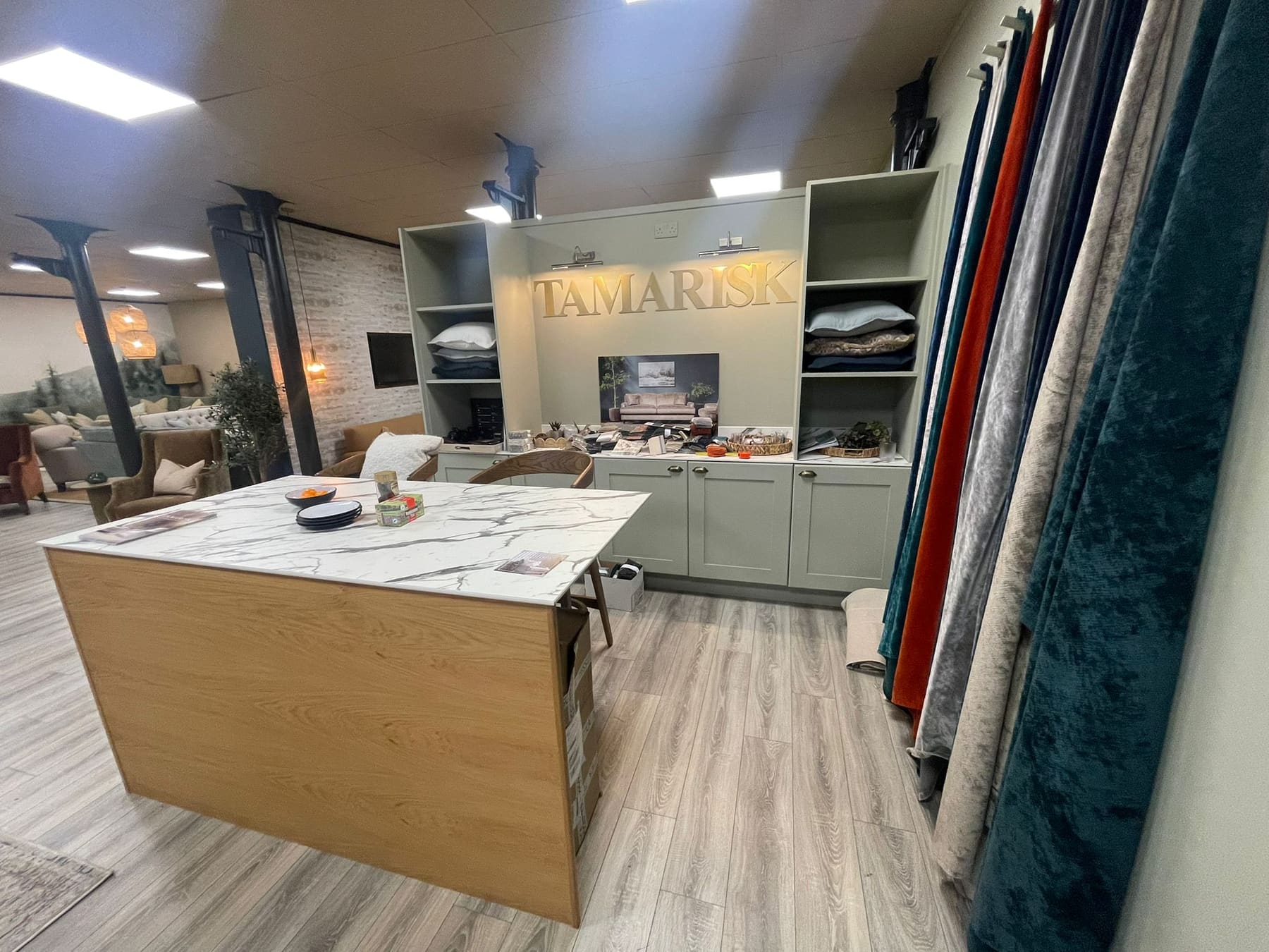 Interiors showroom with painted display joinery and marble-topped island
