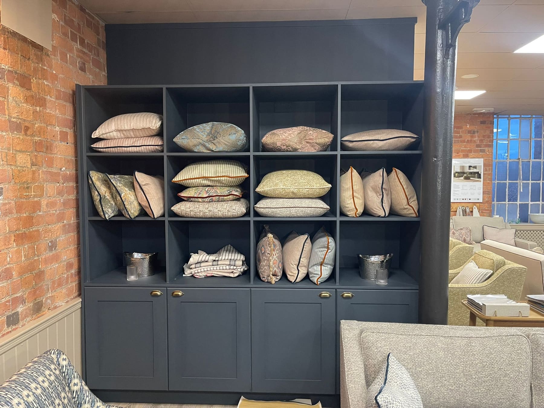 Navy cube shelving against the brickwork